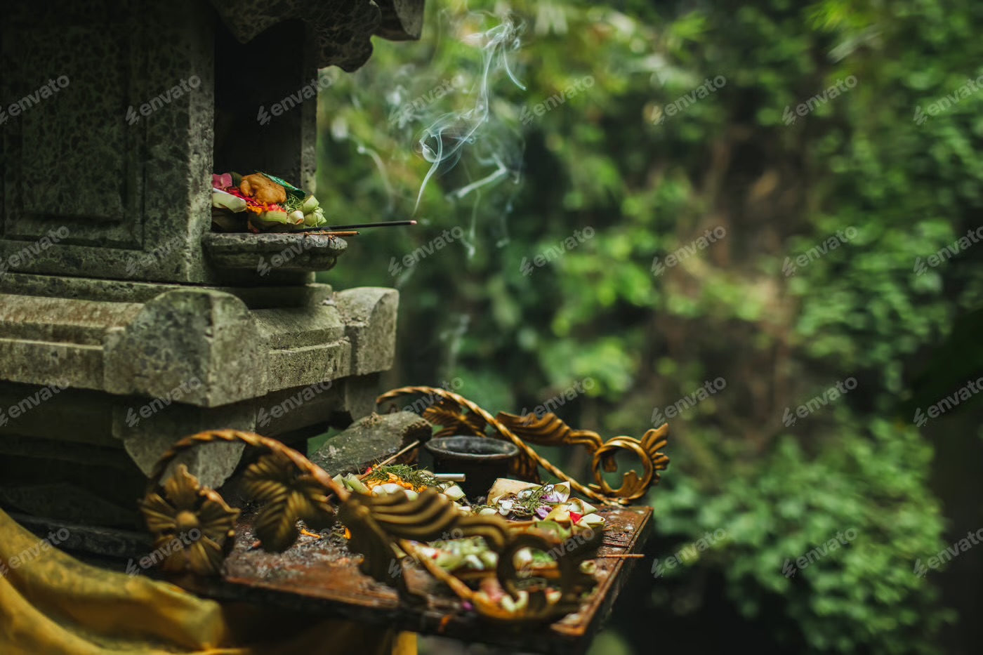 Flower offerings and smoking incense at a Balinese garden shrine